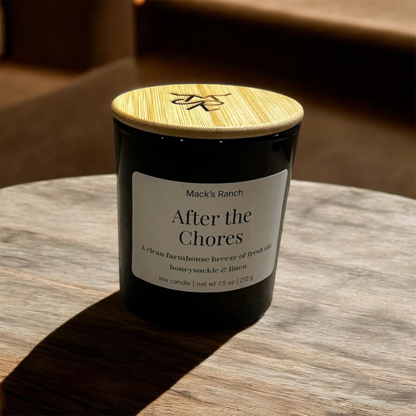 After the Chores soy candle with lantern light on wooden counter - fresh air and soft florals scent.